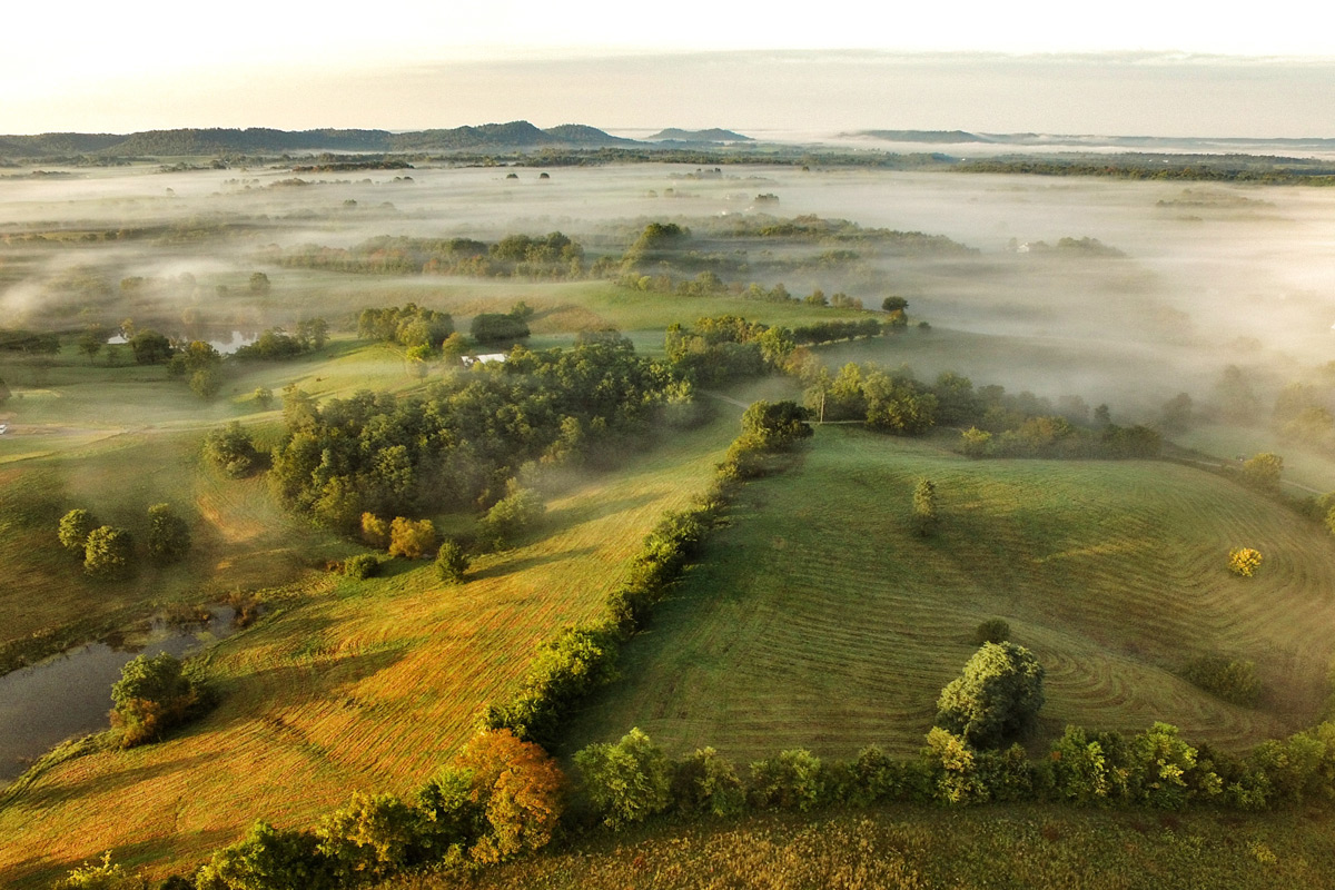aerial photo of foggy farm land